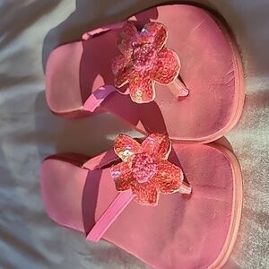 Fun pink sandals with beaded and sequined flowers.